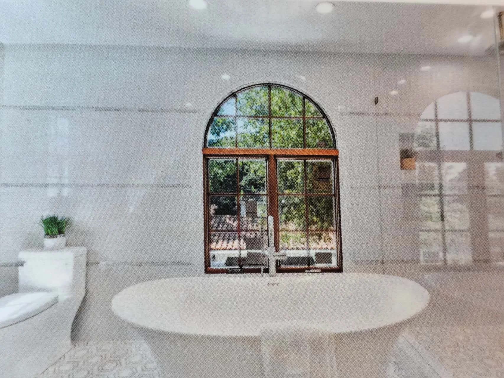 Renovated bathroom with arched window